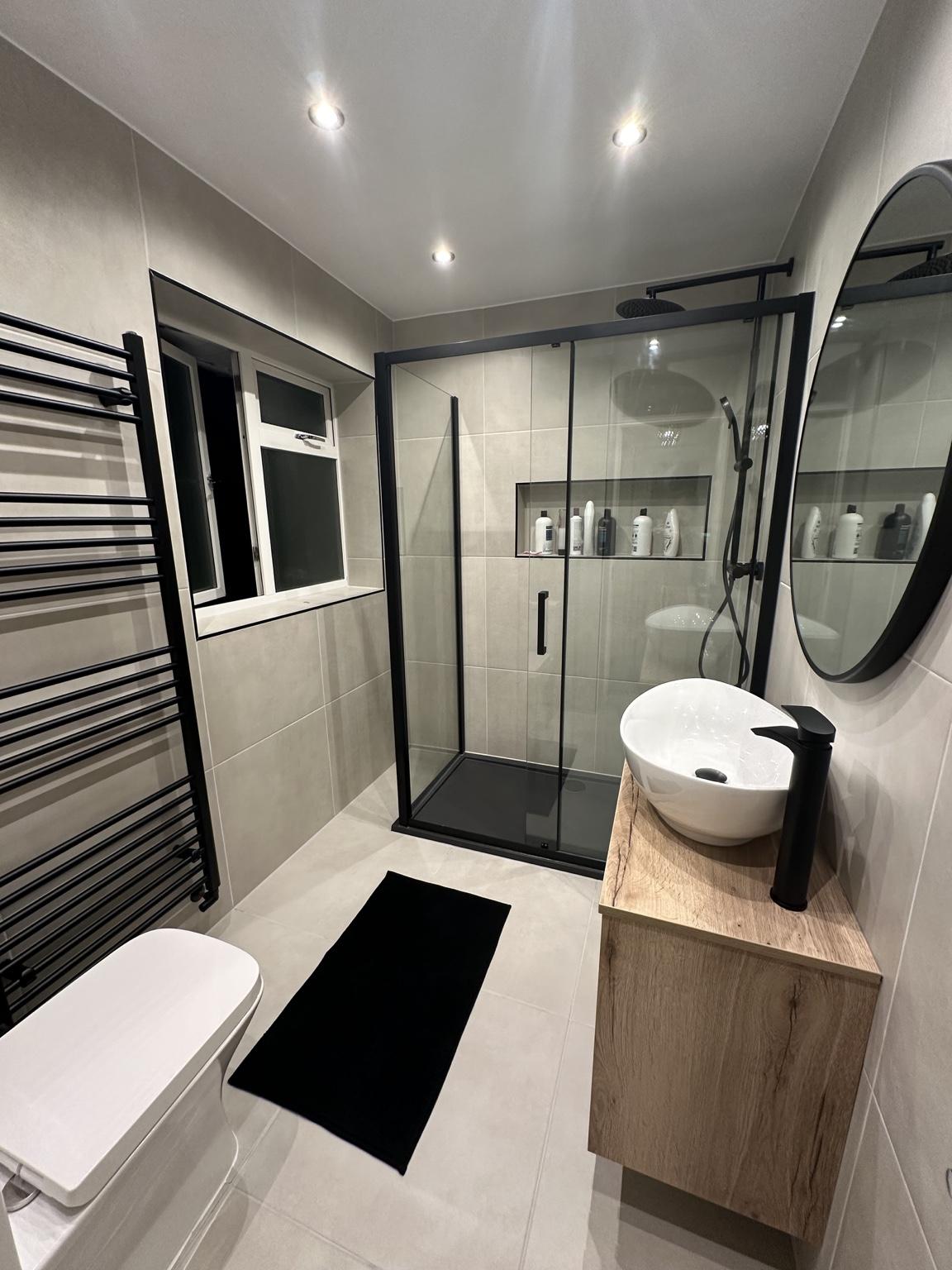 Modern black-frame walk-in shower — completed bathroom