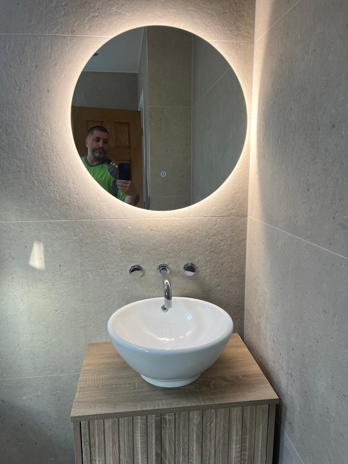 Backlit circular mirror and vessel basin
