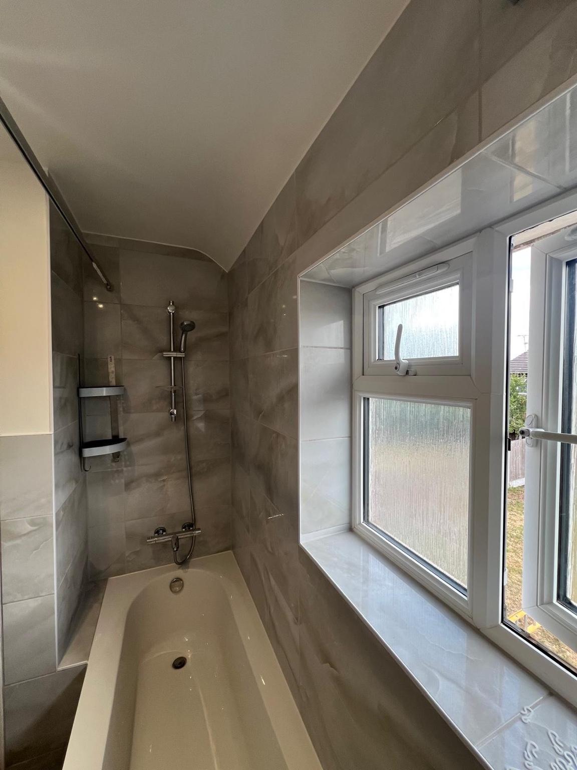 Shower wall and bath from the window side