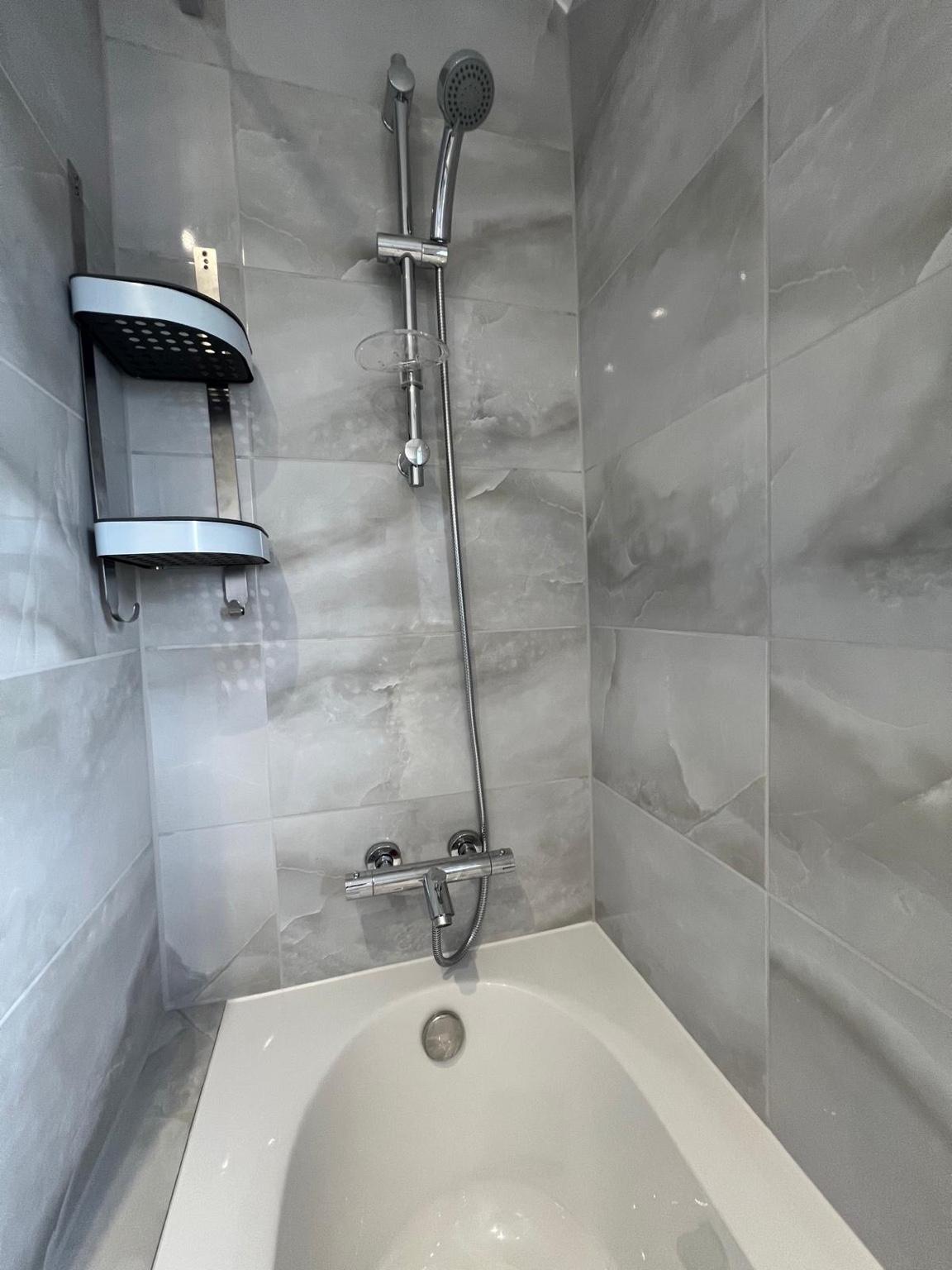 Chrome shower fitting over the bath
