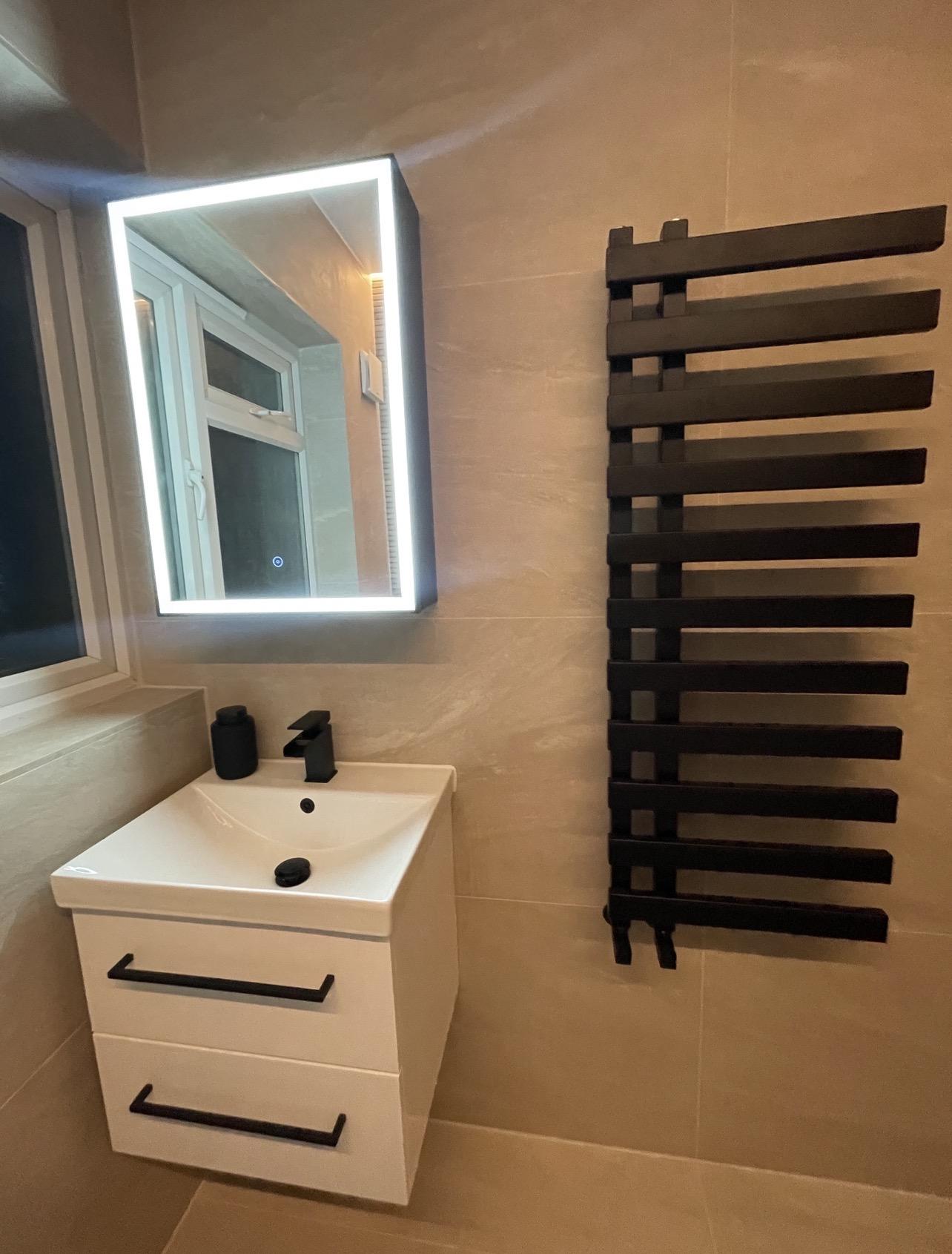 Vanity and black towel radiator