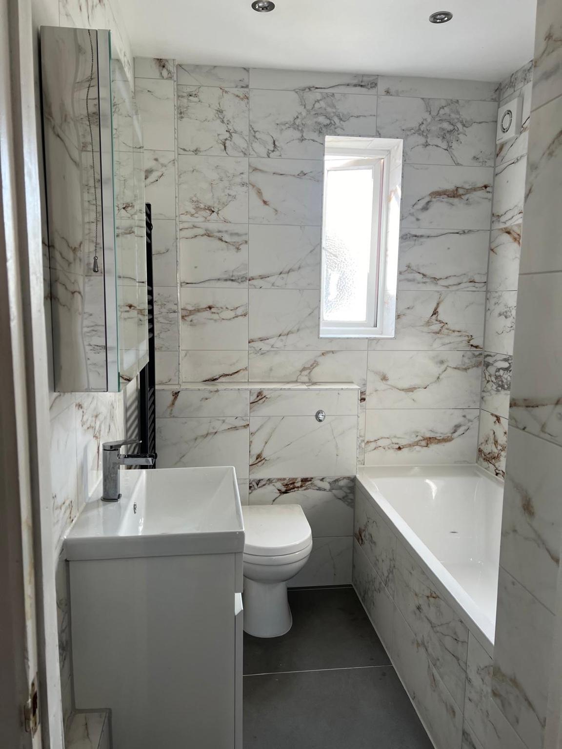 Marble-effect bathroom renovation — completed bathroom