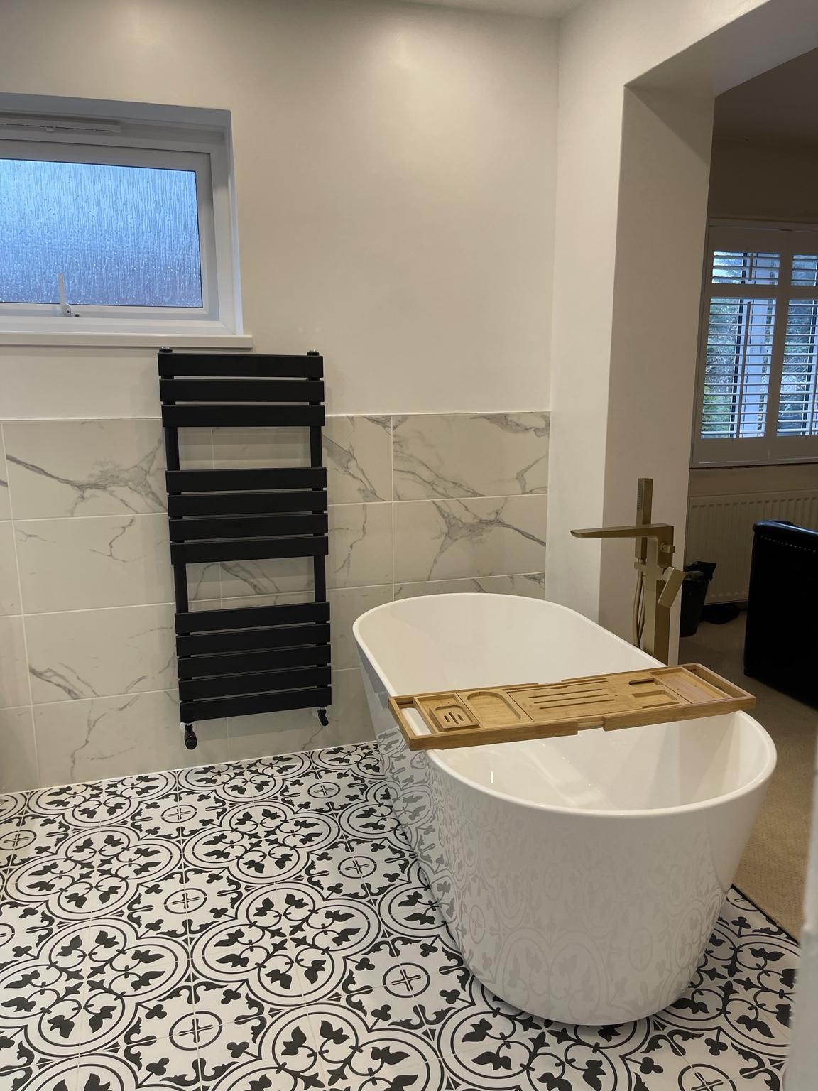 Bath and bedroom seen across the open plan room