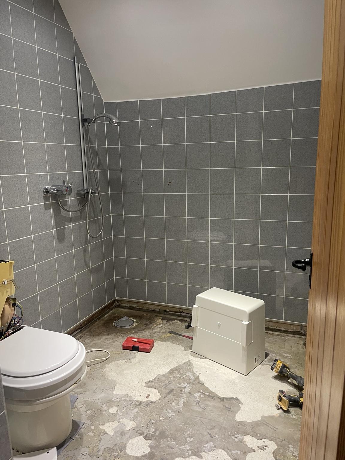 Seamless microcement wetroom during renovation, view 1