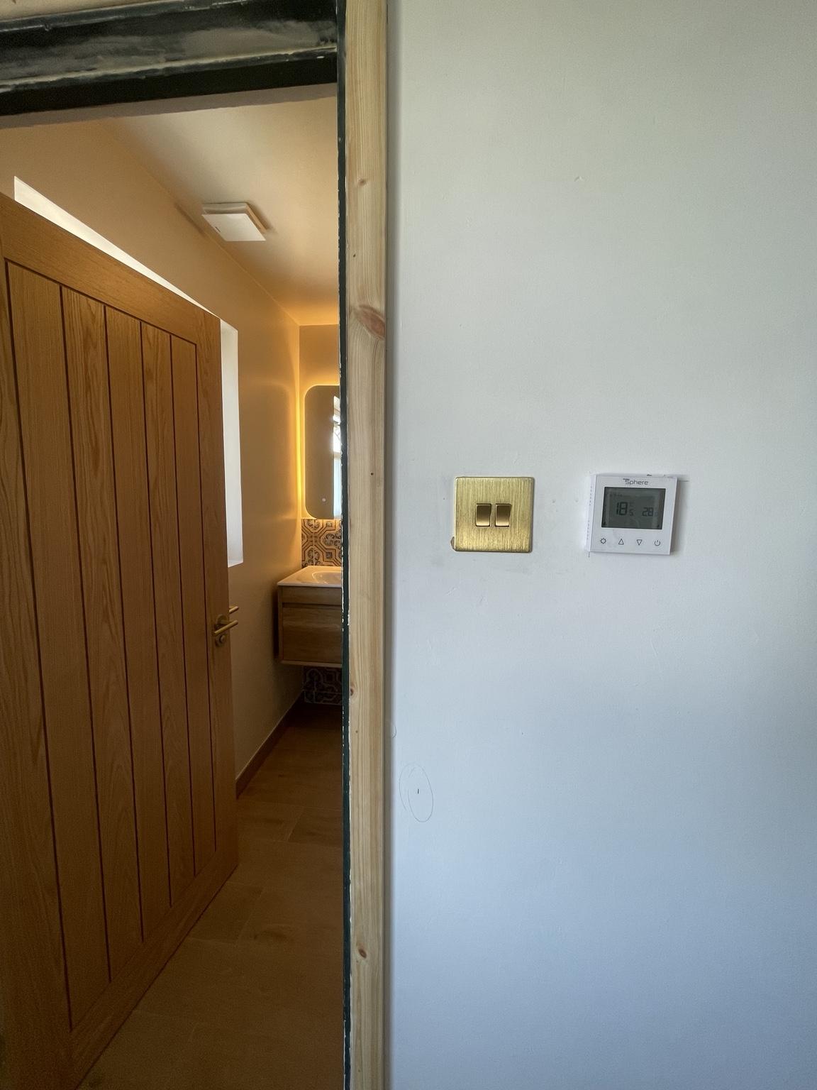 Electric underfloor heating control beside the bathroom