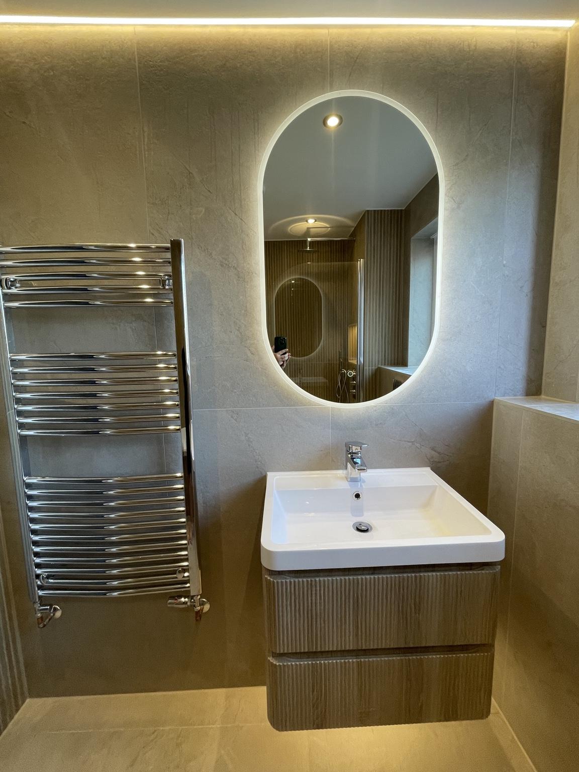 Vanity and illuminated oval mirror